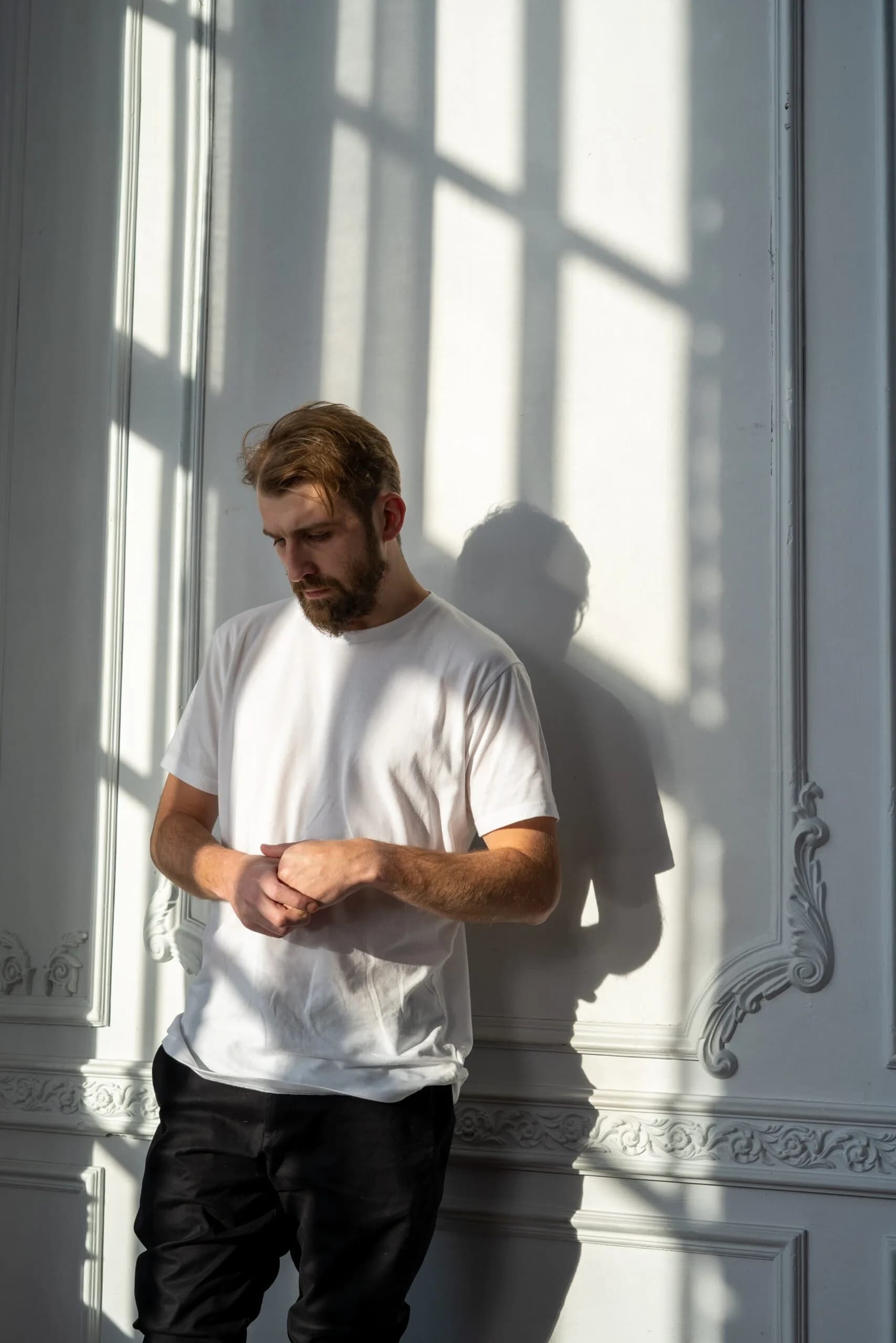 man looks down representing schizophrenia