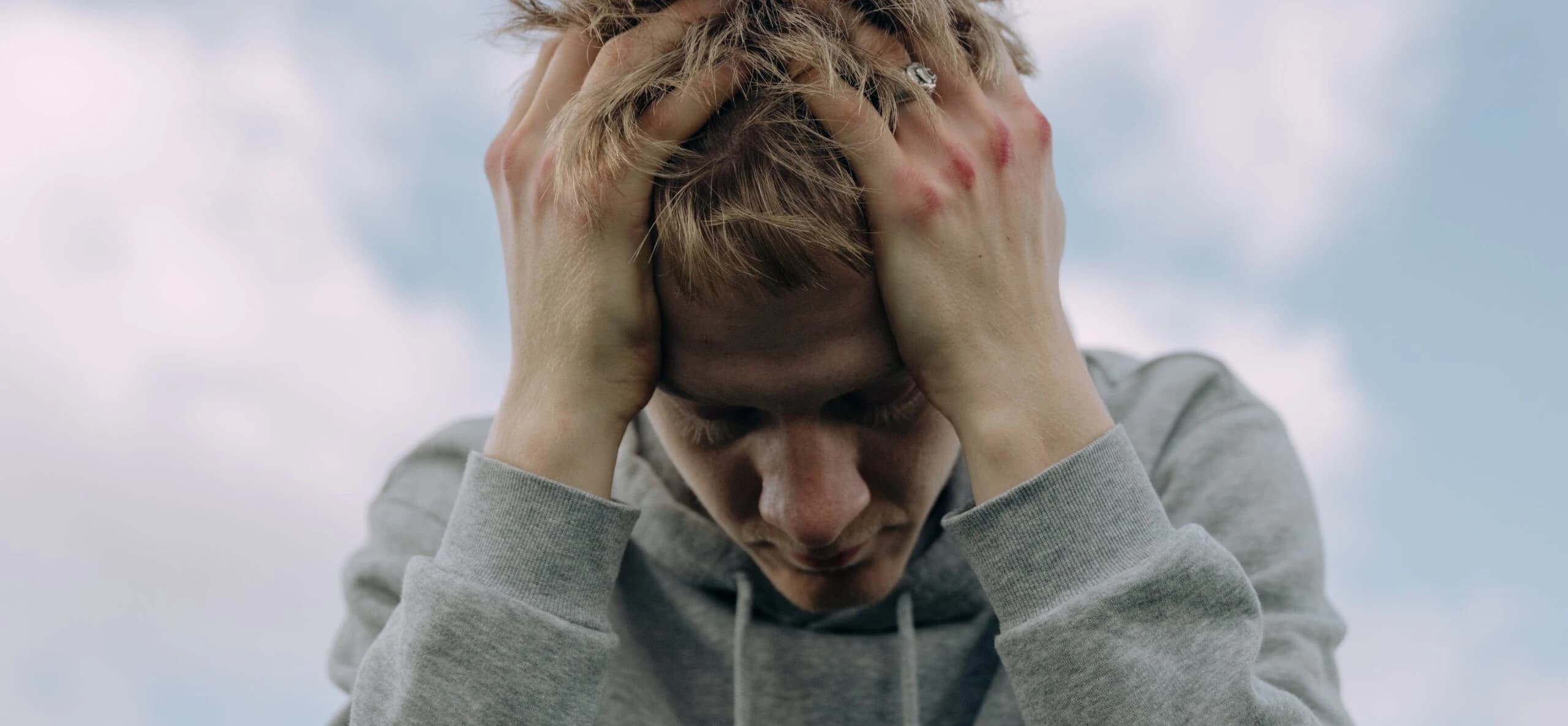 man's head is in his hands representing 5 stages of depression